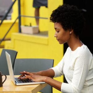 attractive-young-woman-using-laptop-outside-P9RLFGU@2x-1024x798