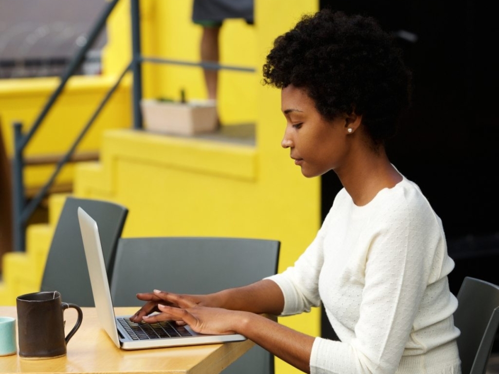 attractive-young-woman-using-laptop-outside-P9RLFGU@2x-1024x798